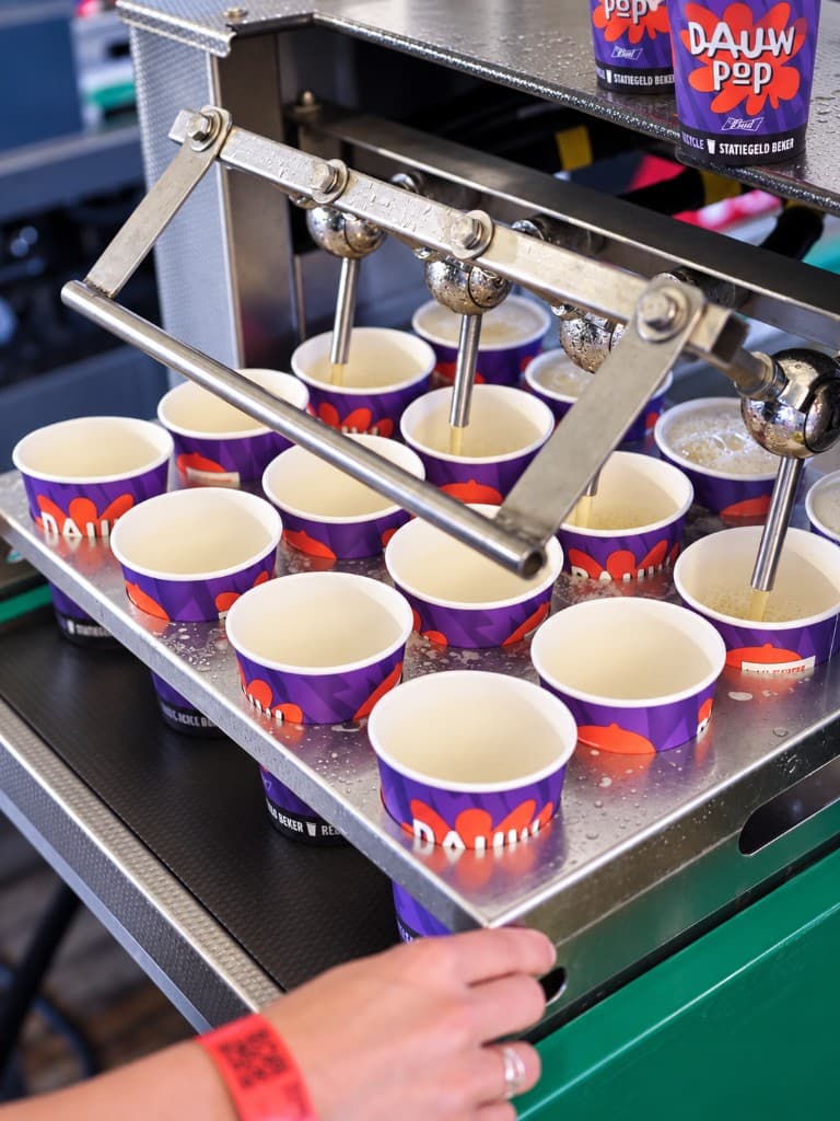 Dauwpop cups being filled at a festival bar