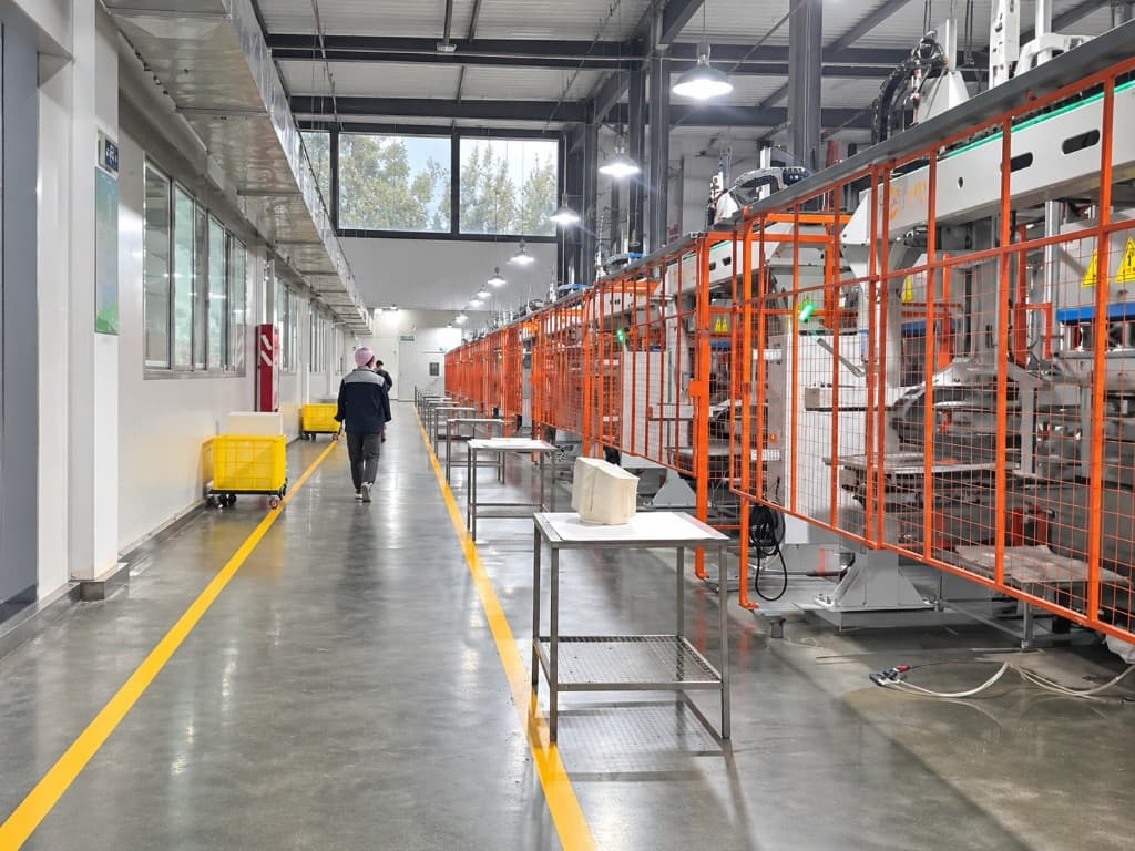 Factory corridor with production machinery and yellow floor markings